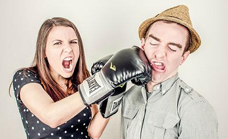 stock image of woman punching man