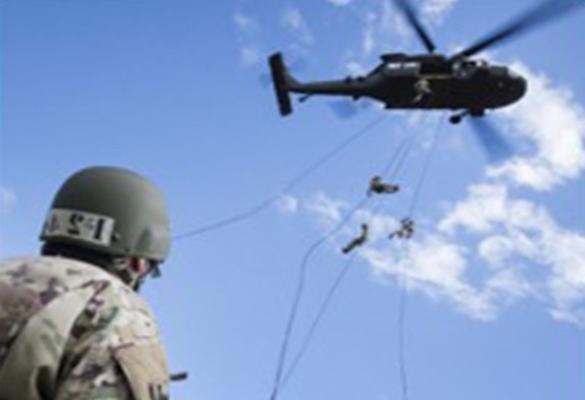 ROTC Student looking up at a helicopter during training